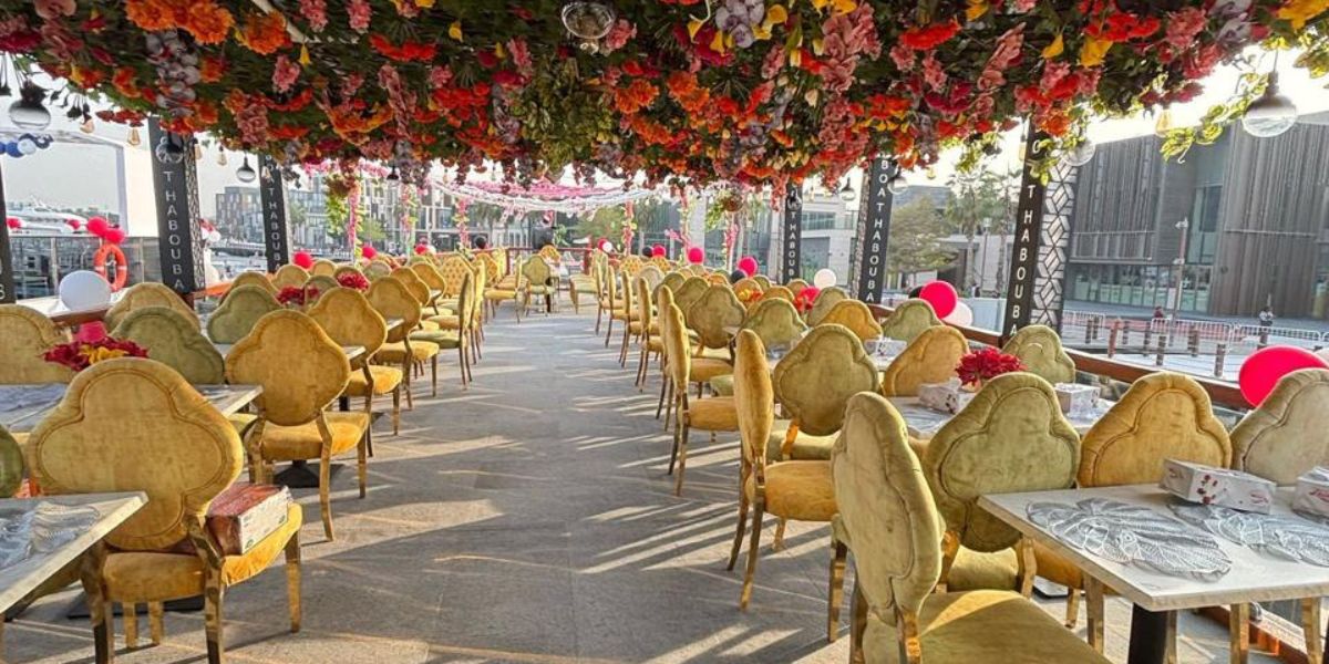 Al Seef dhow cruise dinner seating area with decorated tables and outdoor dining setup