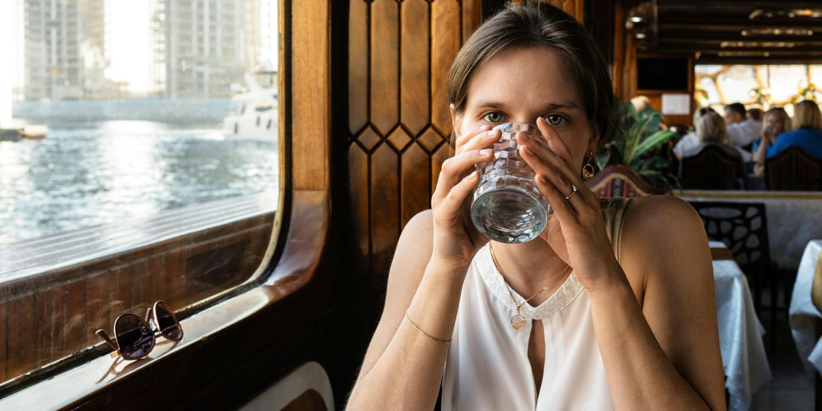 Dubai Marina dhow cruise dinner experience with guest enjoying drinks inside traditional boat