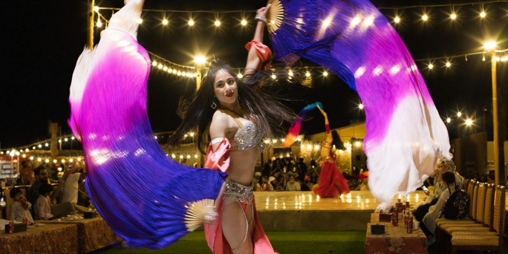 evening desert safari dubai belly dance performance live entertainment desert camp